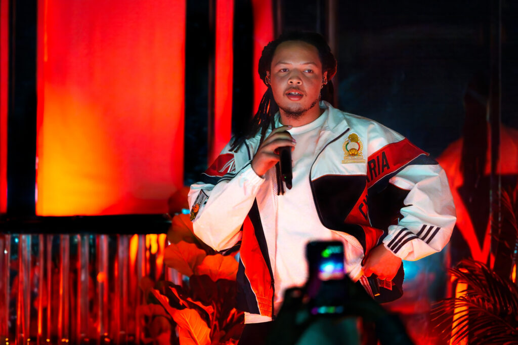 Domani-The-Echo-Los-Angeles-June-23-2026-by-Zharmaine-Boatman-IG-zharmaaaine-8 – The 824 Journal Male singer on stage under red lighting, holding a microphone and performing live.