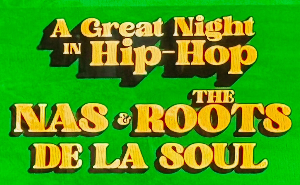 IMG_0195 – The 824 Journal Green poster advertising a hip-hop night with Nas, The Roots, and De La Soul; bold yellow text reads 'A Great Night in Hip-Hop' with 'The Nas & Roots' and 'De La Soul' shown prominently.