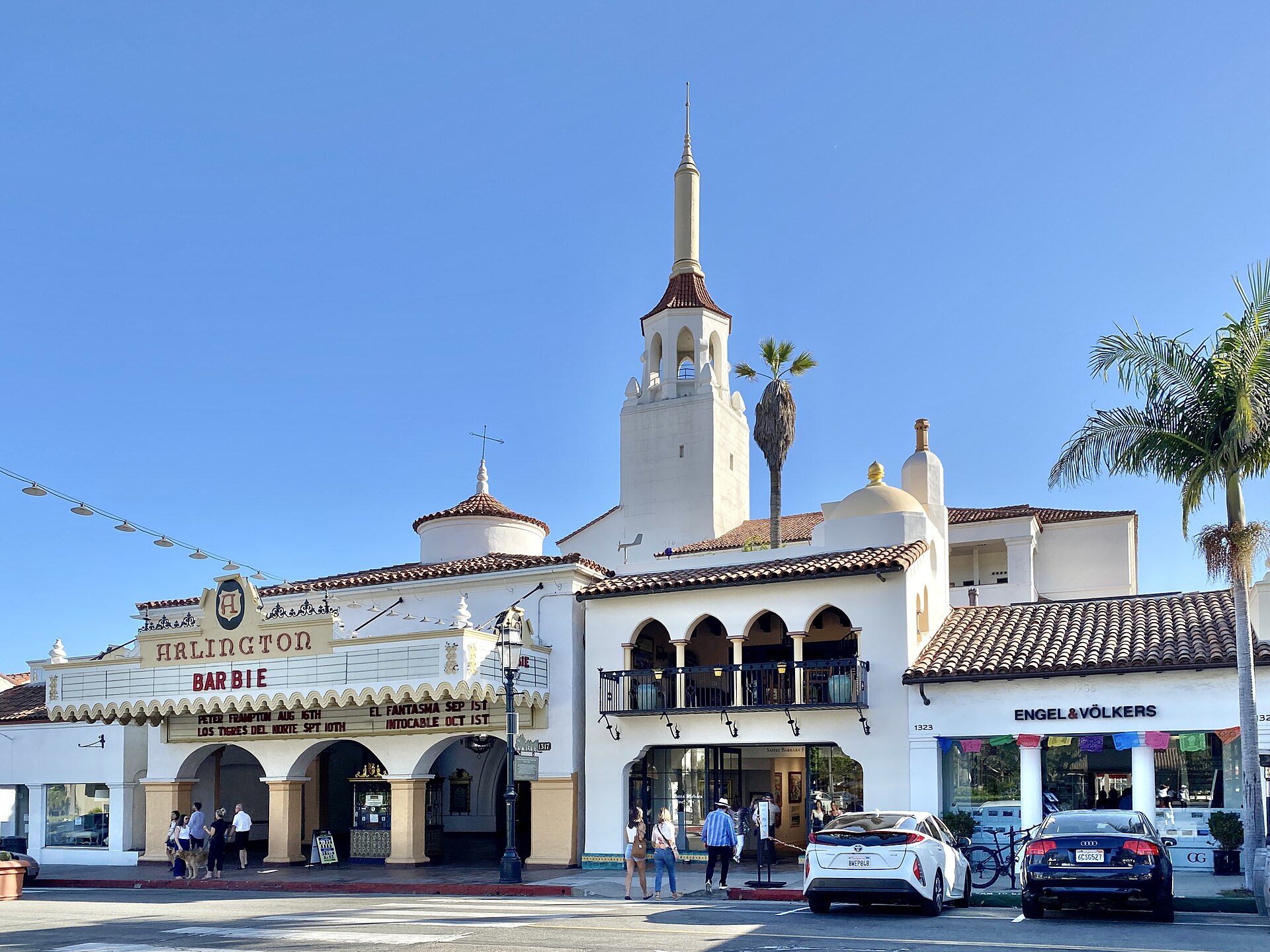 The Spanish Colonial Revival facade and tower of the Arlington Theatre on State Street in Santa Barbara under a blue sky