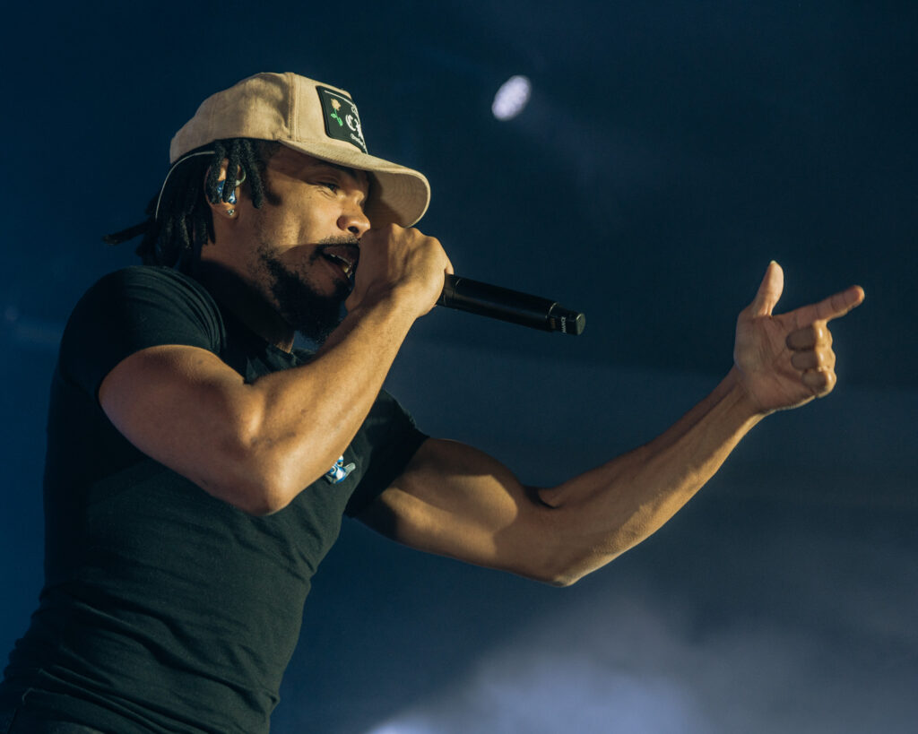 Chance the Rapper at Hollywood Palladium, Los Angeles, September 20, 2026 (14) – The 824 Journal Chance the Rapper rapping and gesturing to the audience through blue stage haze at the Hollywood Palladium.