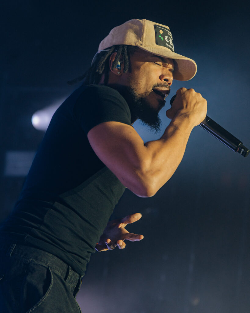 Chance the Rapper at Hollywood Palladium, Los Angeles, September 20, 2026 (16) – The 824 Journal Chance the Rapper leaning into a song, microphone in hand, against a deep blue backdrop at the Hollywood Palladium.