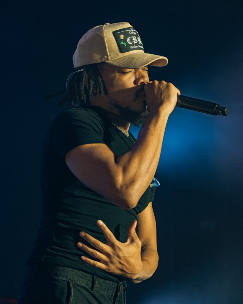 Chance the Rapper at Hollywood Palladium, Los Angeles, September 20, 2026 (17) – The 824 Journal Chance the Rapper singing into a microphone with a hand on his chest under blue stage lights at the Hollywood Palladium.