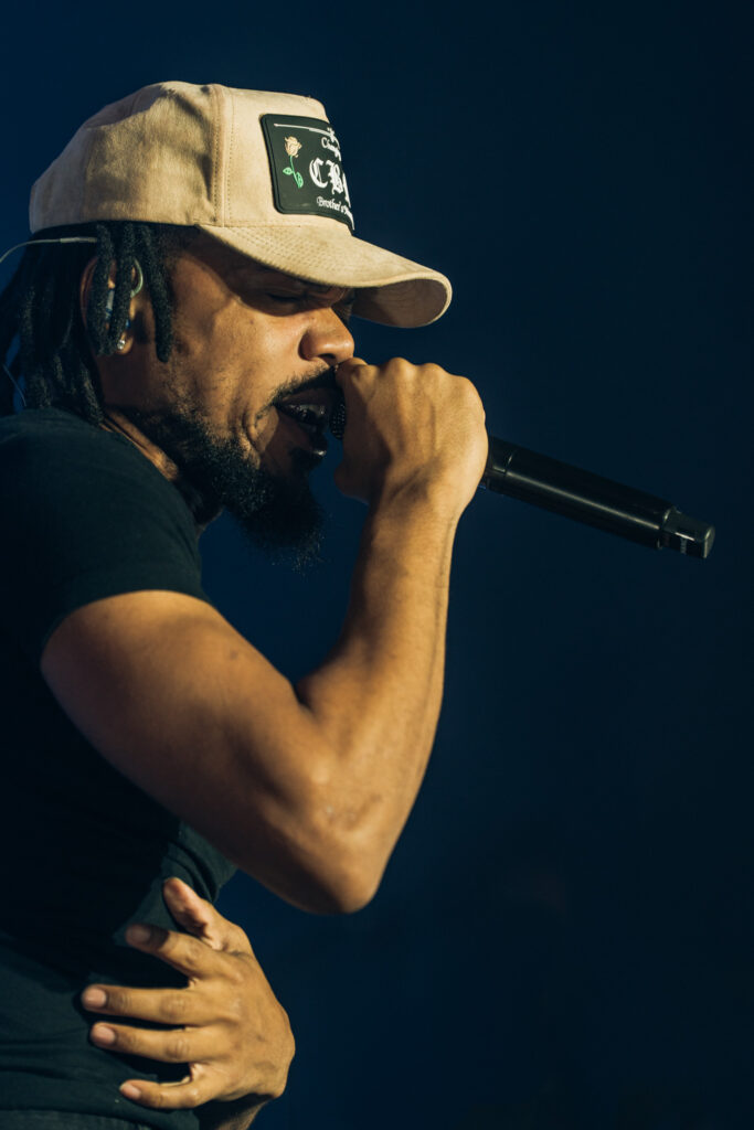 Chance the Rapper at Hollywood Palladium, Los Angeles, September 20, 2026 (20) – The 824 Journal Chance the Rapper singing into a microphone with one hand at his side against a dark blue backdrop at the Hollywood Palladium.