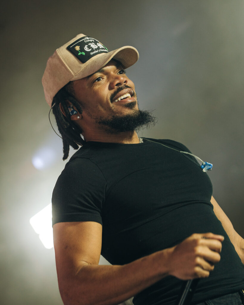 Chance the Rapper at Hollywood Palladium, Los Angeles, September 20, 2026 (24) – The 824 Journal Chance the Rapper smiling and looking upward on stage at the Hollywood Palladium, wearing a tan cap and black shirt.