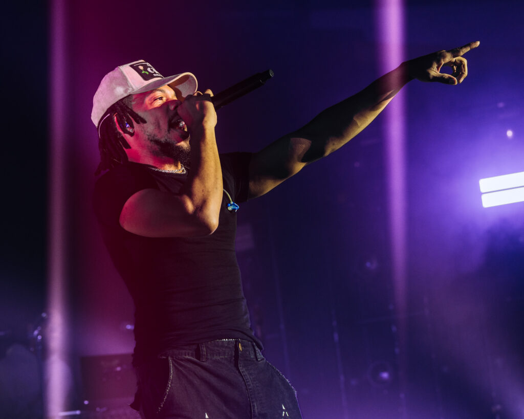Chance the Rapper at Hollywood Palladium, Los Angeles, September 20, 2026 (26) – The 824 Journal Chance the Rapper reaching his arm toward the crowd under colorful stage lights at the Hollywood Palladium, microphone in hand.