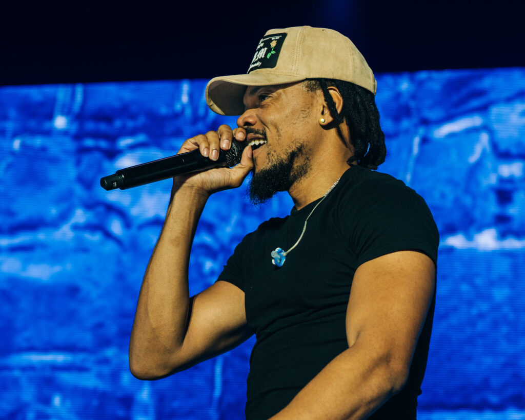 Chance the Rapper at Hollywood Palladium, Los Angeles, September 20, 2026 (9) – The 824 Journal Chance the Rapper rapping into a microphone in front of a bright blue video screen at the Hollywood Palladium.