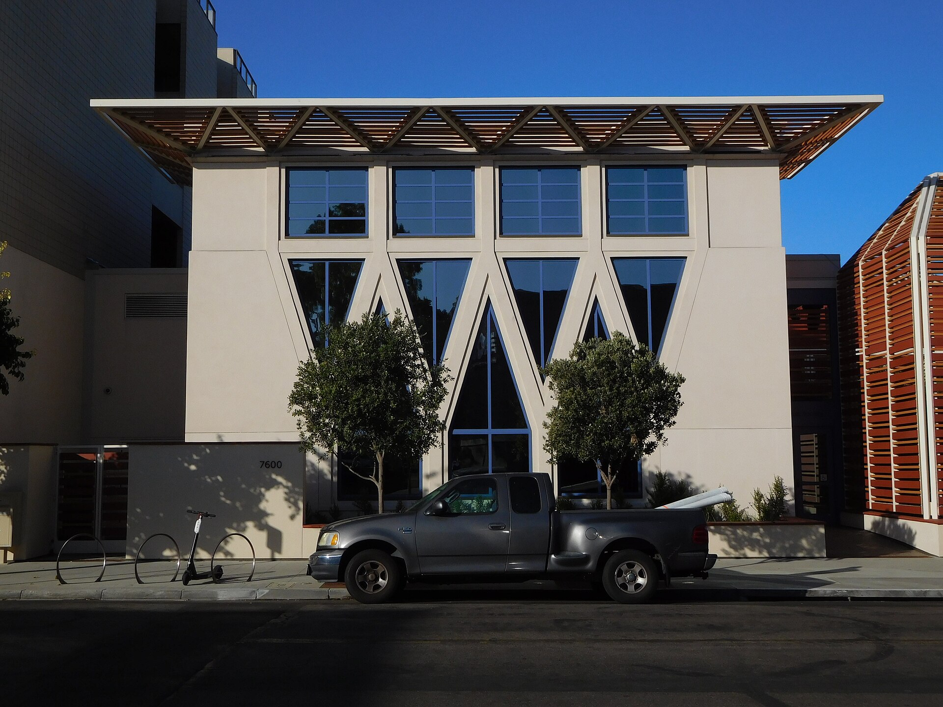 The modern cream-colored facade of the Conrad Prebys Performing Arts Center on Fay Avenue in La Jolla under a blue sky