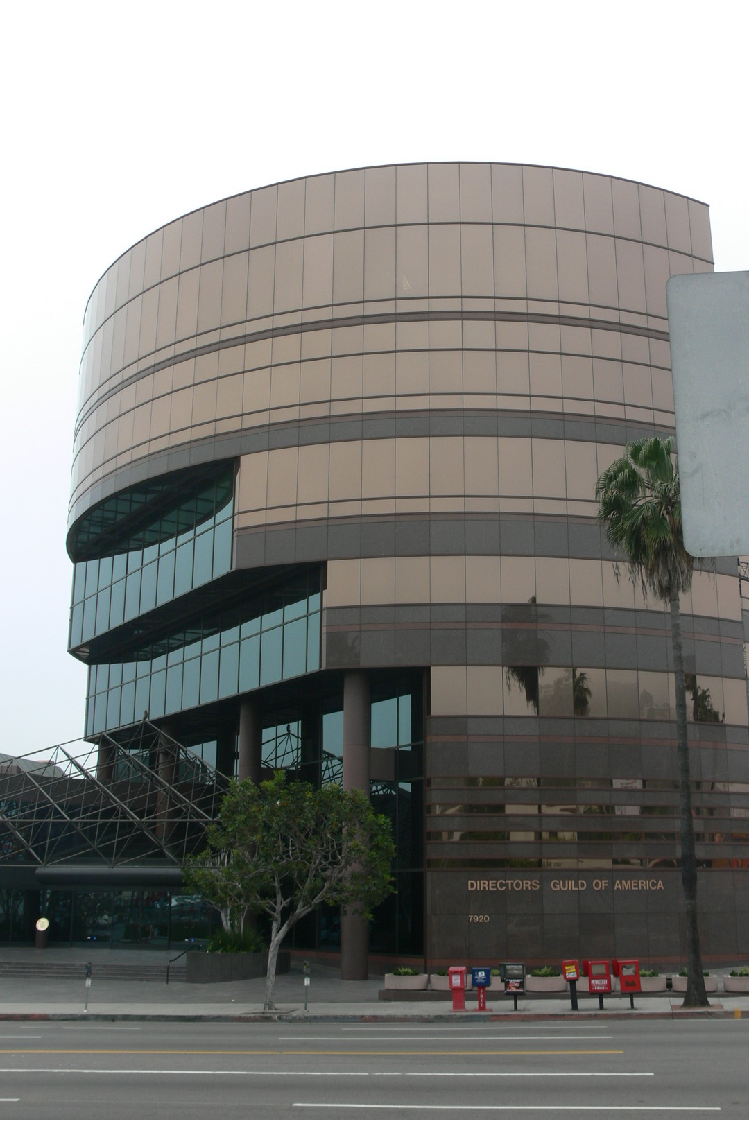 The rounded, tiered facade of the Directors Guild of America headquarters building on Sunset Boulevard under a clear sky