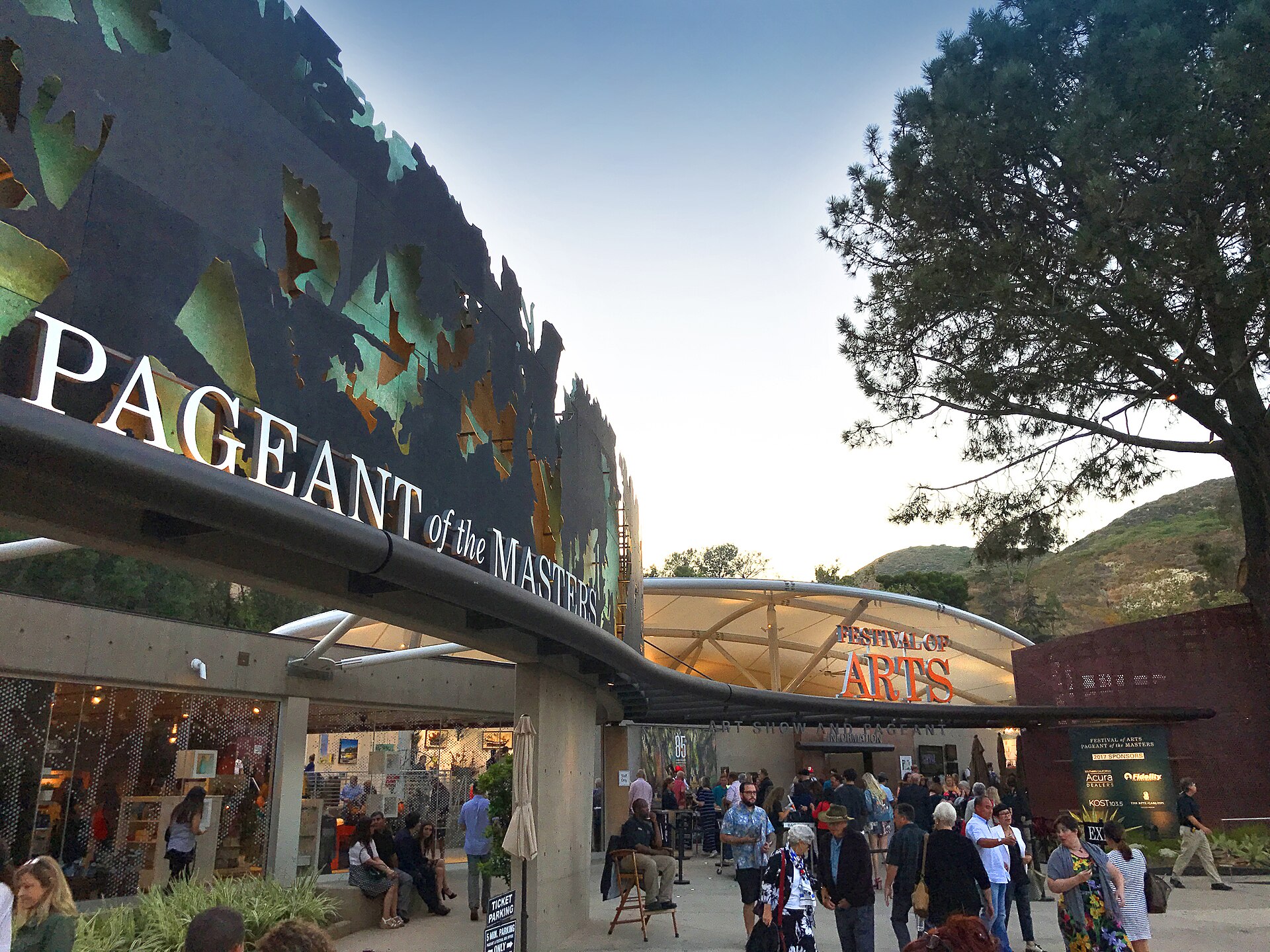 The Pageant of the Masters entrance at the Festival of Arts grounds in Laguna Beach, with visitors walking under trees