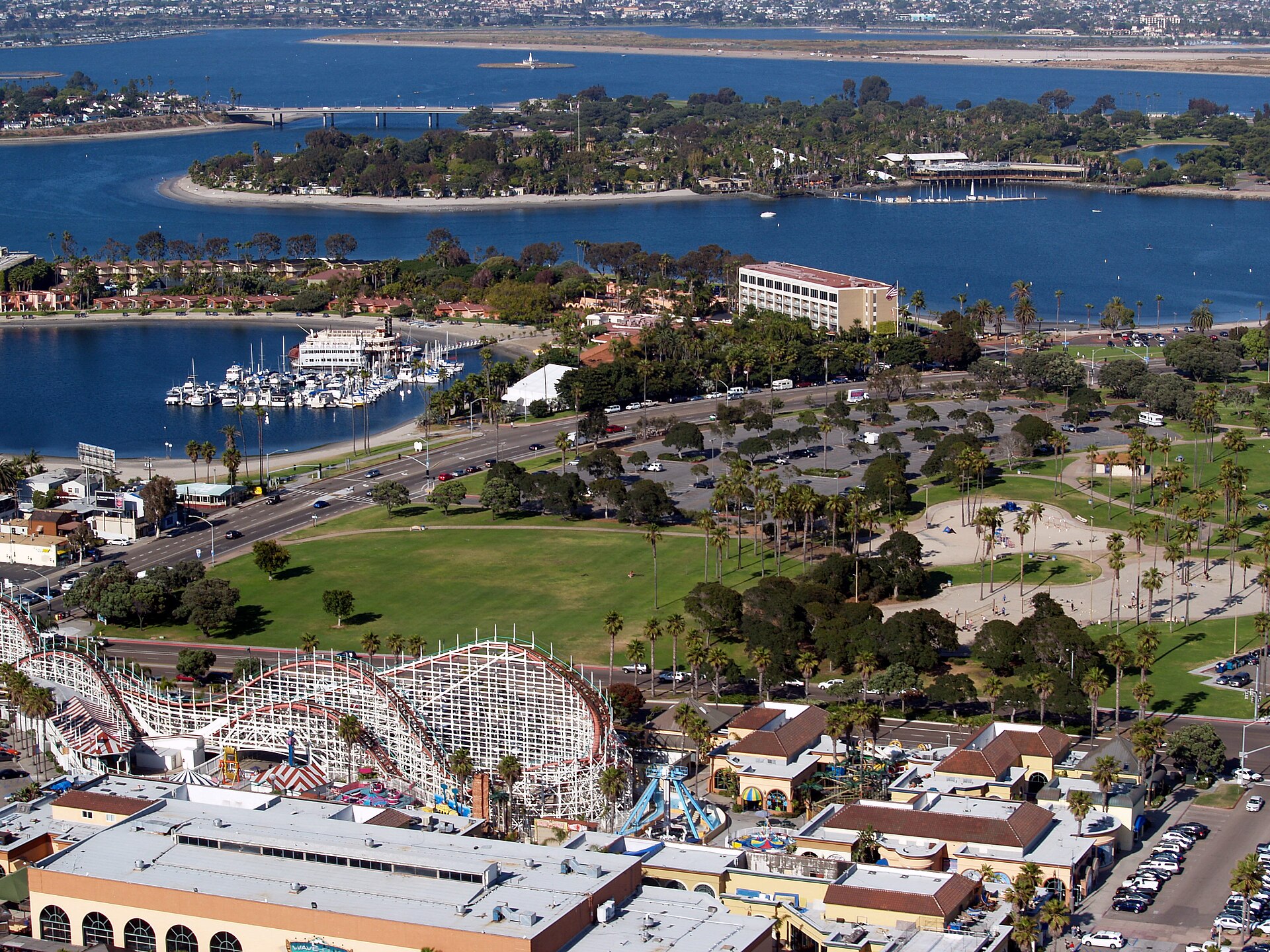 Aerial view of Mission Bay in San Diego, with the Giant Dipper roller coaster, Bonita Cove, and the bay's islands and marinas