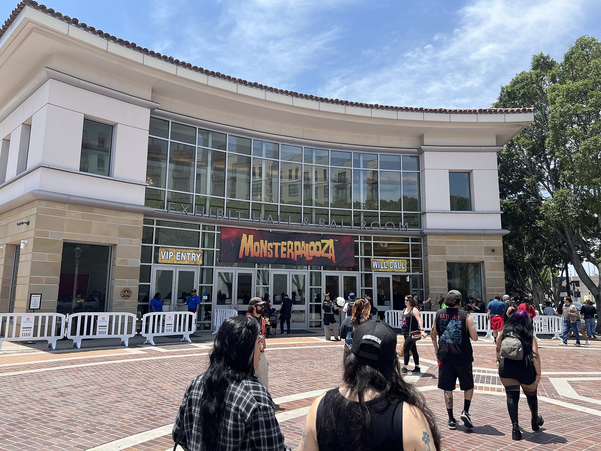 Fans gather outside the Pasadena Convention Center, with a Monsterpalooza banner over the entrance, during the 2025 spring show