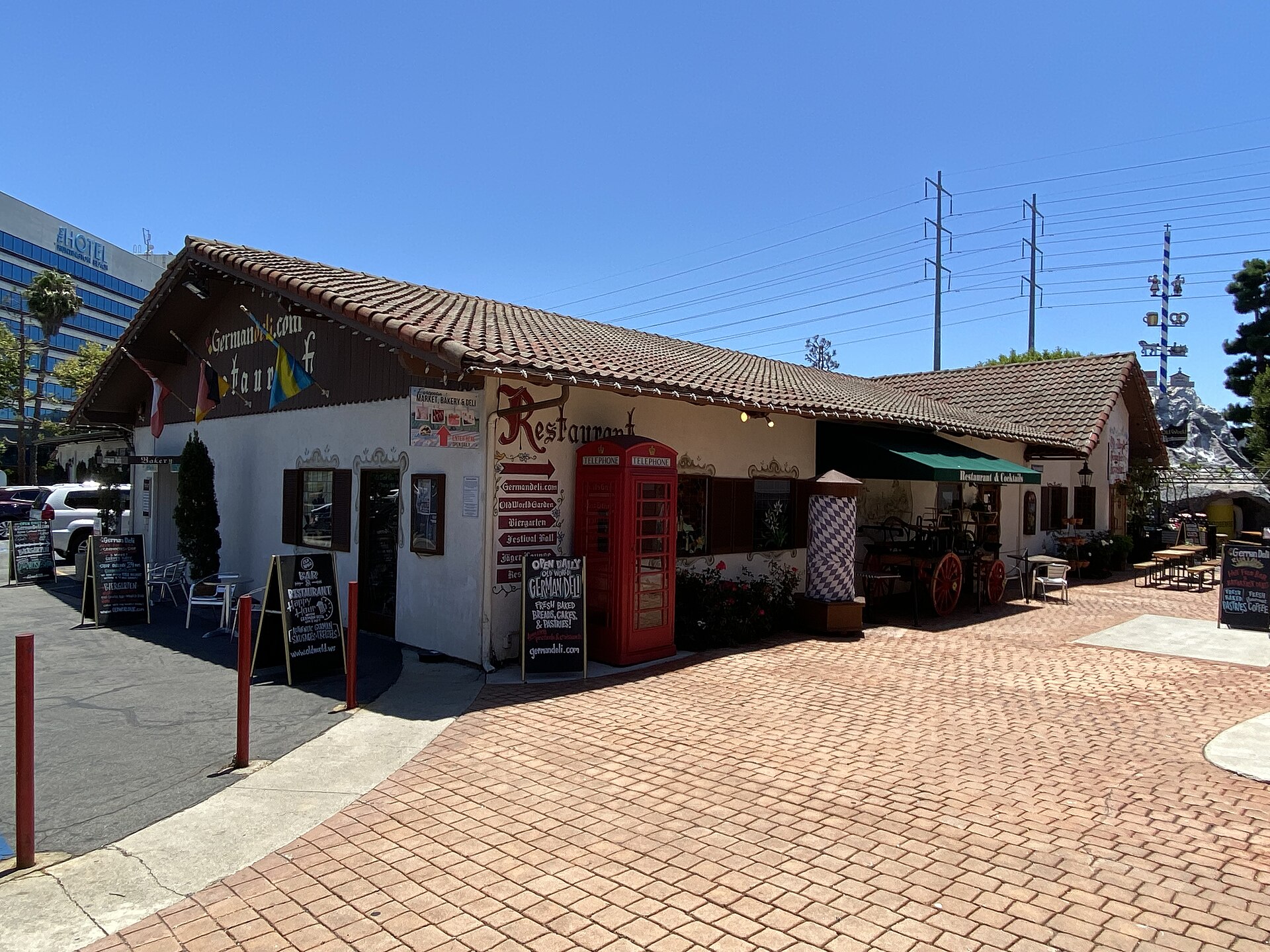 Bavarian-style German restaurant and market building with a brick courtyard at Old World Village in Huntington Beach