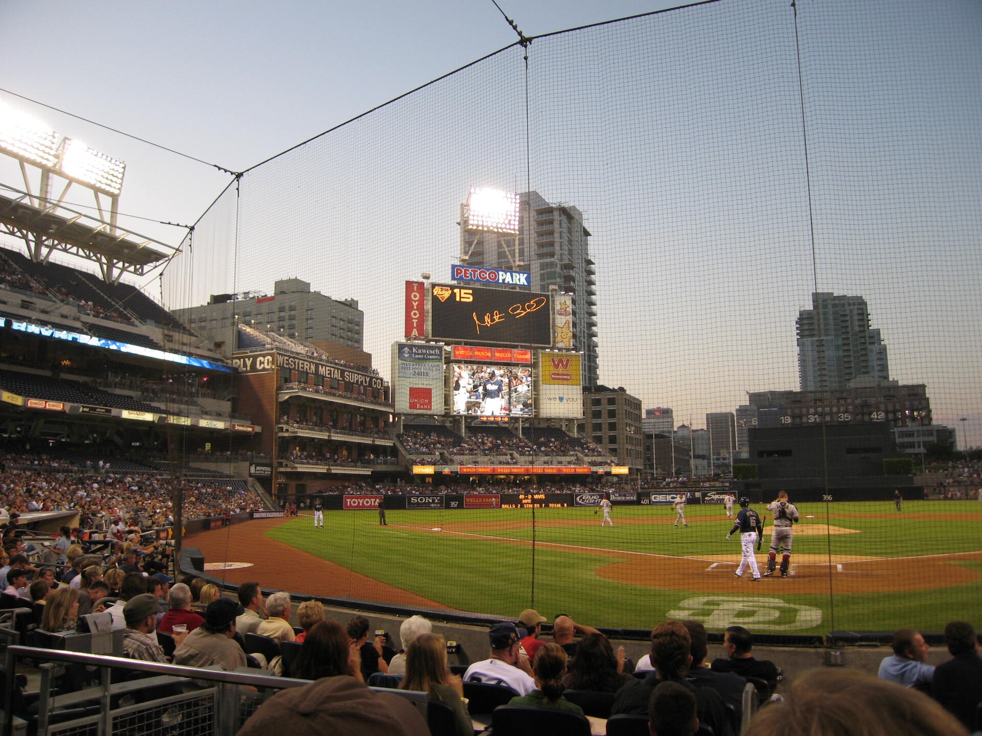 Petco Park's field and seating bowl at dusk with the downtown San Diego skyline behind the outfield