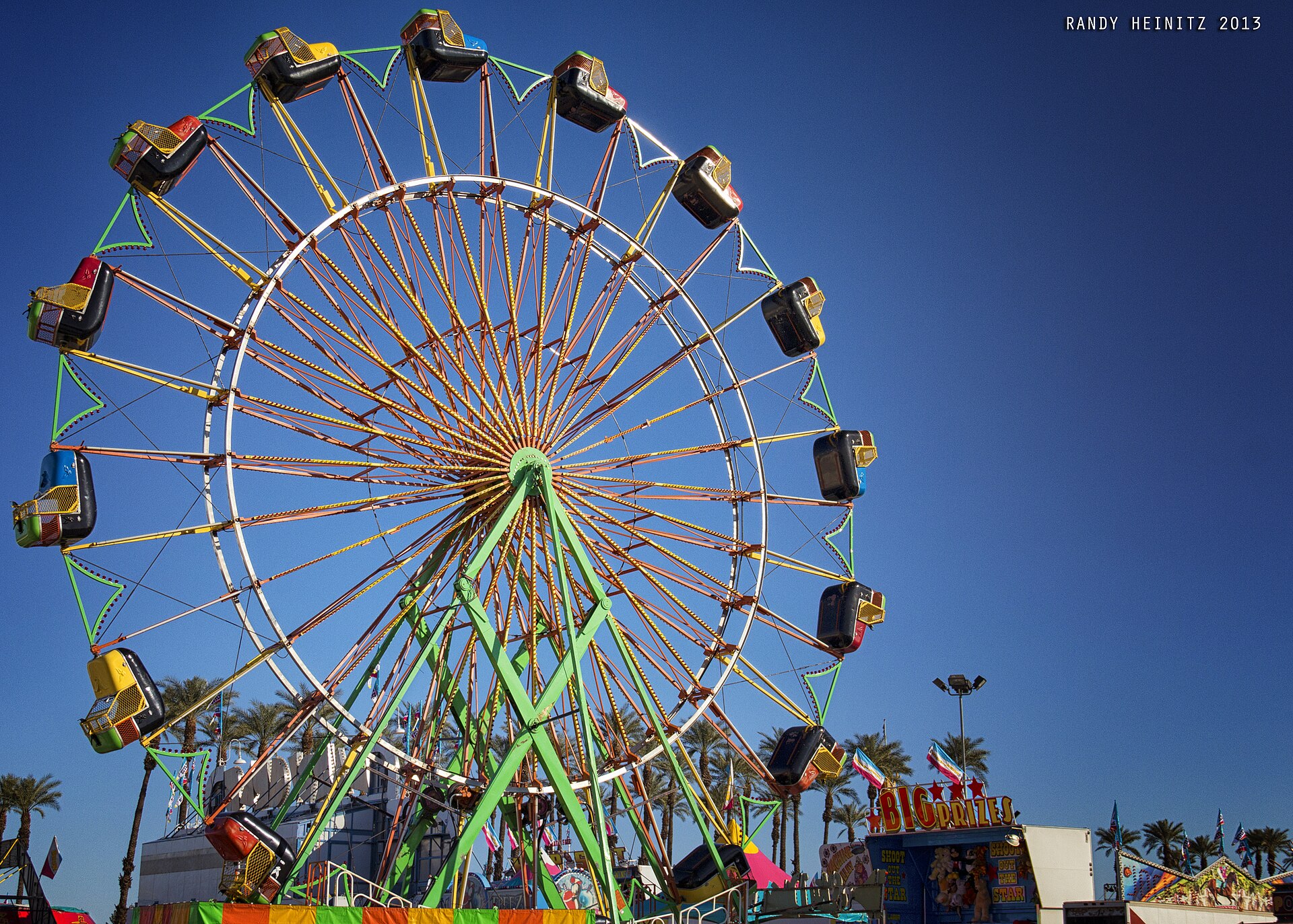 A tall wheel-shaped Skydiver carnival ride against a blue sky at the Riverside County Fair and National Date Festival in Indio