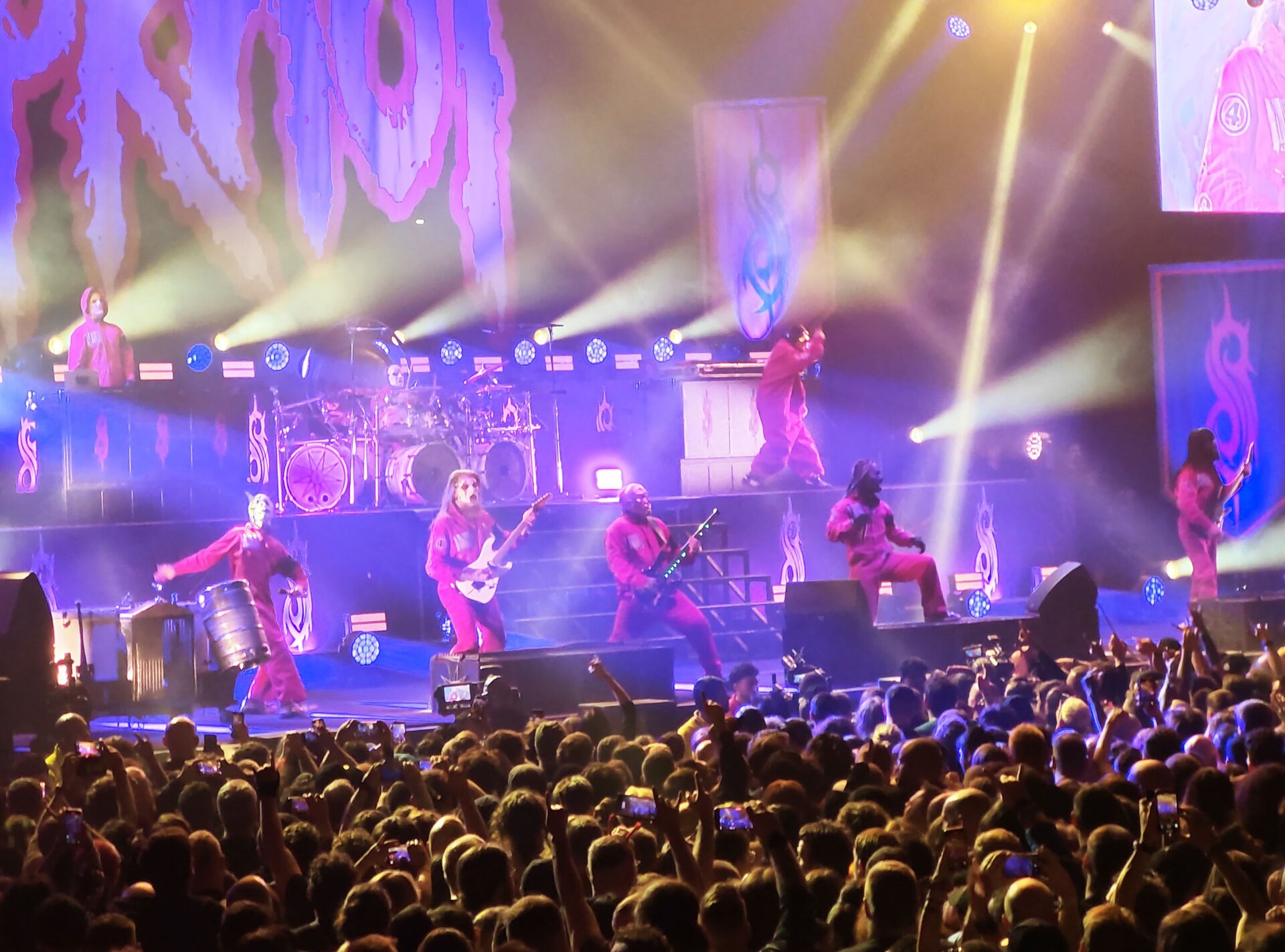 Slipknot performing on stage at the O2 Arena in London under purple and white stage lights, December 2024