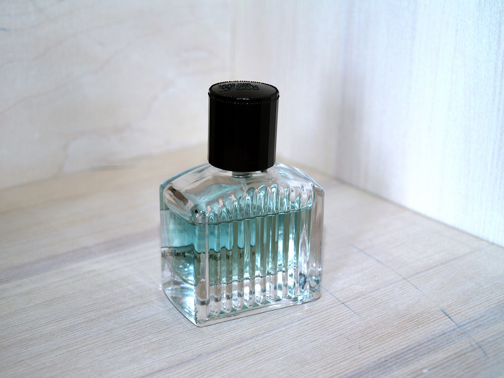 Glass perfume bottle on a light background