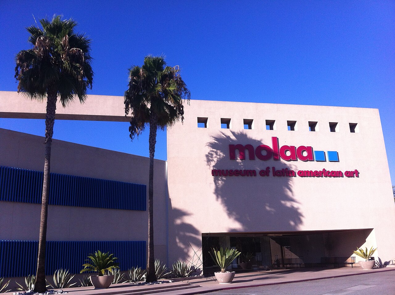 The front of the Museum of Latin American Art in Long Beach, with its MOLAA sign and two palm trees